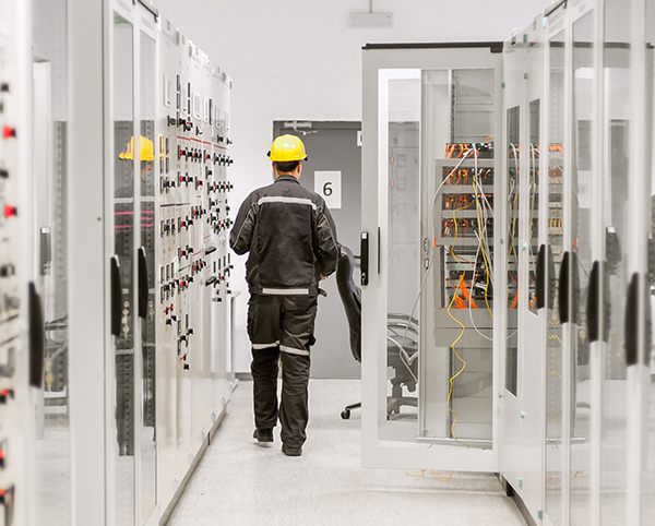 A worker does a walk through in a mission critical systems facility